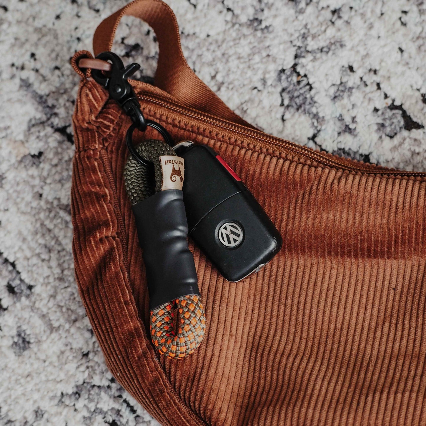 Eco-friendly two-tone rope keychain made from repurposed climbing rope scraps, featuring unique colors and handcrafted for a stylish, sustainable accessory.