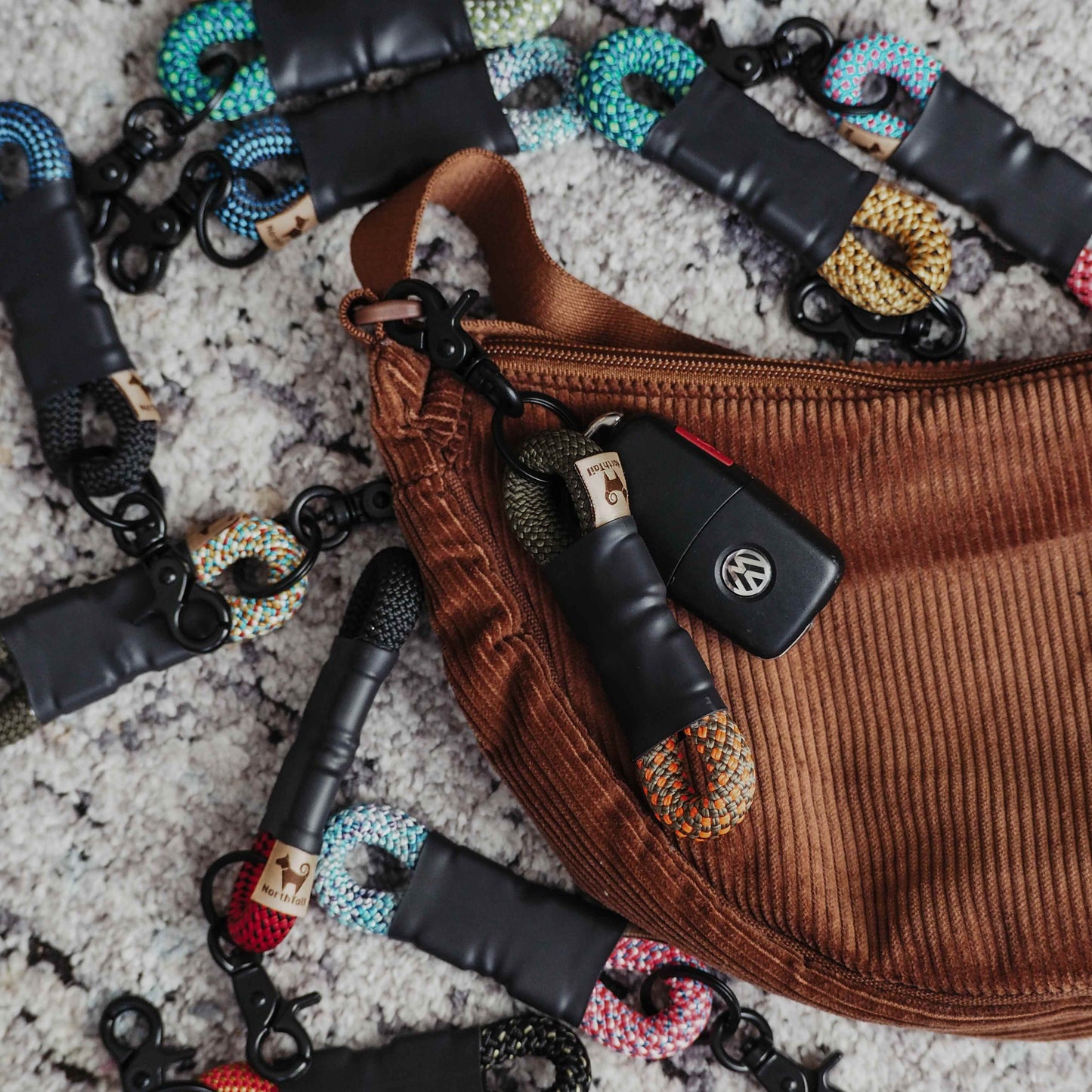 Eco-friendly two-tone rope keychain made from repurposed climbing rope scraps, featuring unique colors and handcrafted for a stylish, sustainable accessory.